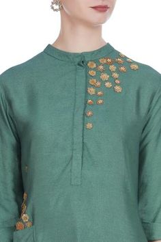 For a traditional look at work, pick this green silk blend tunic. It features 3D flower motif embroidery. Team it up with gold-toned pants to complete the look. 
Mandarin collar
Utility pockets
Three quarter sleeves - Aza Fashions Silk Kurta With Embroidered Neckline And Long Sleeves, Elegant Green Chanderi Blouse, Green Straight Kurta With Embroidered Neckline, Green Straight Kurta Dress With Embroidered Neckline, Festive Tunic Kurta With Embroidered Neckline, Green Embroidered Neckline Straight Kurta Dress, Green Blouse With Resham Embroidery For Eid, Elegant Green Blouse With Floral Embroidery, Festive Silk Tunic With Floral Embroidery