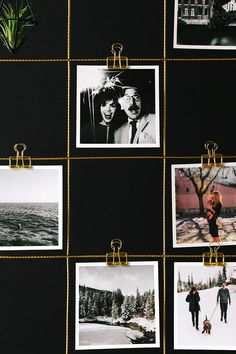 black and white photographs hanging on a wall with gold clips attached to them, along with photos of people walking in the snow