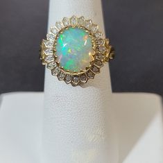 an opal and diamond ring is on display