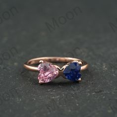 Unique Heart Shaped Pink Sapphire And Blue Sapphire Dainty Ring 14K Rose Gold Bow Tie Design Wedding Ring Two Stone Promise Rings For Women ◈ Item Details ◈ Metal: 925 Sterling Silver  Style: Gemstone Ring Main Stone: Pink Sapphire  Main Stone Color: Pink Main Stone Shape: Heart Secondary Stone: Sapphire  ( Lab-Created ) Secondary Stone Color: Blue Secondary Stone Shape: Heart ABOUT GEMSTONE - ♥ Purification ♥ Serenity ♥ Protection ♥ Wisdom ♥ Balance ♥ Strength ♥ Friendship ♥ Love ♥ Positive thinking ♥ Sensitivity S I L V E R J E W E L R Y C A R E Silver is not the best friend of oxygen and sulfur; it can be oxidized and tarnished from time to time it is the nature of silver. To keep the silver shiny and prevent it from oxidizing fast, we would recommend the following instructions; * Avoid Rose Gold Birthstone Heart Ring For Promise, Rose Gold Birthstone Heart Promise Ring, Rose Gold Sapphire Promise Ring With Birthstone, Rose Gold Double Heart Ring For Wedding, Rose Gold Birthstone Promise Ring For Valentine's Day, Pink Gold Heart Ring For Valentine's Wedding, Rose Gold Proposal Rings For Mother's Day, Pink Gold Heart Ring For Wedding Or Valentine's Day, Rose Gold Promise Ring For Valentine's Day