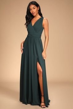 a woman in a long green dress with a slit down the side and one leg