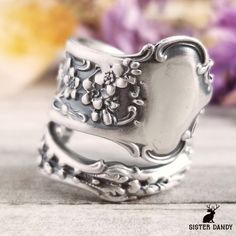 Delicate Forget-me-not flowers unfurl on this ring in art nouveau style. Originally made from a Whiting spoon made in the early 1900s, this lovely ring would make a perfect gift for any gardener or lover of flowers! This ring is made from a vintage sterling silver spoon, 925, nickel-free. This ring will be adjusted to the size you request but it can easily be tightened or loosened at home should you want a different fit. As these are antique items, there may be minor wear and tear from its past Silver Flower Ring For Promise, Engraved Flower Ring For Wedding, Vintage Engraved Ring In Antique Silver For Wedding, Silver Promise Flower Ring, Antique Flower Jewelry For Anniversary, Antique Silver Ornate Rings For Anniversary, Nickel-free Heirloom Rings For Anniversary, Nickel-free Open Ring Wedding Jewelry, Ornate Antique Silver Rings For Anniversary