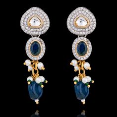 Dive into the symphony of blue elegance designed to make you feel like royalty! Adorn this one-of-a-kind jewelry set mesmerizing with radiant sapphire stones that beautifully complement different shades of blue beads along with sparkling CZ stones and delicate kundan accents with white and green moti, creating a spellbinding glow. The set includes a necklace and a pair of straight drop earrings. Approximate earrings length is 2". Pair our stunning Mohini Set with Nirali Bangles. Please click on Elegant Stone Earrings For Festive Occasions, Blue Fusion Style Jewelry For Celebration, Elegant Blue Stone Earrings, Elegant Blue Earrings With Stones, Fusion Style Blue Kundan Jewelry, Blue Fusion Style Jewelry For Wedding, Blue Fusion Style Wedding Jewelry, Festive Fusion Blue Earrings, Blue Kundan Jewelry For Formal Occasions