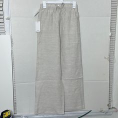 These Are High-Rise Wide-Leg Pants With An Elastic Waist And Drawcord. They’re Cut From Soft, Drapey Fabric Made With Linen And Tencel Lyocell Responsibly Sourced Wood-Based Fibres Produced Through A Closed-Loop System That Reduces Environmental Impact. Materials & Care Content: 66% Tencel Lyocell, 34% Linen Care: Machine Wash Imported Rise: High Leg: Wider Length: Full Intended To Hit At The Ground While Wearing Flat Shoes A Size L Will Fit Someone Who Typically Wears A 12 In Other Aritzia Clot Spring Beige Wide Leg Loungewear Pants, Beige Wide Leg Pants For Spring Loungewear, Spring Beige Wide Leg Pants For Loungewear, Beige Wide-leg Pants For Daywear, Beige Wide Leg Pants For Spring Daywear, Casual Beige Wide-leg Pants, Cream Pants For Daywear In Spring, Cream Pants For Spring Daywear, Neutral Wide Leg Pants For Loungewear