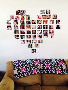 a love heart made out of photos hanging on the wall above a couch with pillows