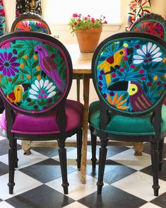 the chairs are decorated with colorful birds and flowers