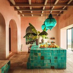 a dining room table covered in blue tiles and potted plants on top of it