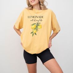 Make Life a Lemonade Stand: Positive Vibes Tee (100% Cotton) Turn life's sour moments into something sweet with this uplifting 100% cotton tee.  Featuring the refreshing message "Lemonade Out of My Life" and playful lemon graphics, this shirt is a reminder to find the sunshine even when faced with challenges. Made with breathable cotton, this tee is perfect for spreading positivity wherever you go. It's a great conversation starter and a way to inspire others to find the good in life. Here's why Casual Yellow T-shirt For Loungewear, Casual Cotton T-shirt With Lemon Print, Casual Lemon Print Tops For Spring, Yellow Printed Relaxed Fit Top, Yellow Printed Tops With Relaxed Fit, Yellow T-shirt With Lemon Print For Spring, Yellow Summer T-shirt For Loungewear, Yellow T-shirt For Summer Loungewear, Everyday Short Sleeve Printed Tops