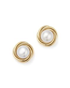 An enduring, elegant knot design in 14K yellow gold encircles beaming pearl studs.