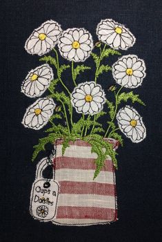 there are white flowers in a red and white striped vase on the black background,