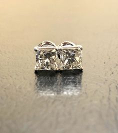 DeKara Designs Collection Metal- 14K White Gold, .583. Stones- EGL USA Certified Princess Cut Diamonds, 1 G Color SI1 Clarity 1.51 Carats, 1 H Color VS2 Clarity 1.51 Carats. Beautiful Handmade Diamond Classic Stud Earrings Made in 14K White Gold Featuring Two 1.50 Carat Near Colorless Certified Princess Cut Diamonds. The diamonds are very close in color, cut, and clarity with extreme fire and brilliance. Each diamond is professionally set in between four prongs. The earrings come with very secur Princess Cut Earrings, Princess Cut Gold, Cut Earrings, Princess Cut Diamond, Diamond Stud Earrings, Princess Diamond, Art Deco Diamond, Diamond Stud, Princess Cut Diamonds