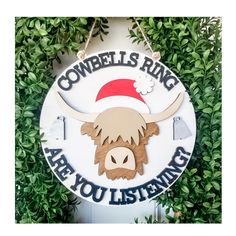 a sign that says cowbells ring are you listening? with a bull's head on it