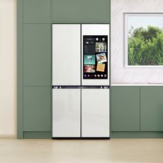 a white refrigerator freezer sitting inside of a kitchen next to a green counter top