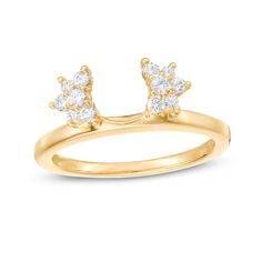 a yellow gold ring with two small white diamonds on the top and one diamond in the middle