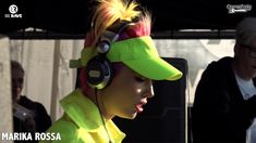 a woman wearing headphones and a yellow hat