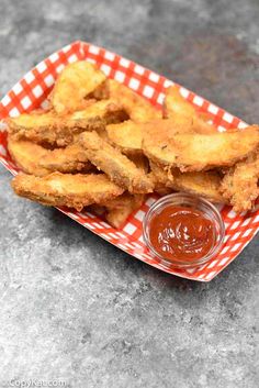 fried chicken sticks with dipping sauce on a plate