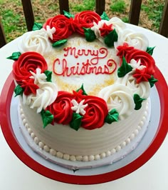 a white cake decorated with red and white flowers