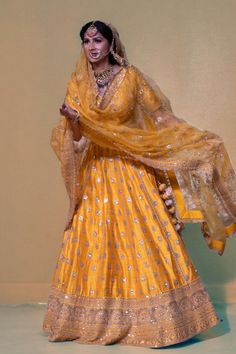 Indulge in the luxurious beauty of this enchanting lehenga, adorned with exquisite mirrors, pearls, stones, and intricate embroidery. This opulent piece will effortlessly enhance your innate elegance and splendor. Color - Yellow Fabric & Work Style - - Silk blouse: mirror, pearl, stone, embroidery work. - Soft net lehenga: mirror, pearl, stone, embroidery work. - Soft net dupatta: embroidery work. Details - - Assured quality - Wash care instruction: Dry clean only. - Slight variation in color is Raw Silk Lehenga With Mirror Work For Reception, Raw Silk Dress With Gota Work For Wedding, Raw Silk Wedding Dress With Gota Work, Elegant Choli With Gota Work For Diwali, Elegant Gota Work Choli For Diwali, Wedding Dresses In Raw Silk With Gota Work, Traditional Raw Silk Lehenga With Gota Work, Raw Silk Sharara With Dupatta For Reception, Elegant Navratri Choli With Gota Work