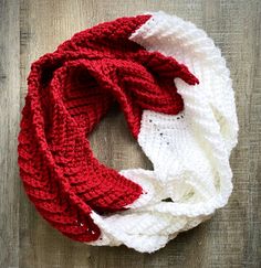 a red and white scarf on top of a wooden table