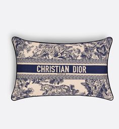 a blue and white pillow with the words christian dior printed on it's side