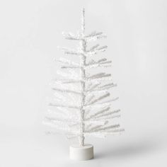 a small white christmas tree on a stand