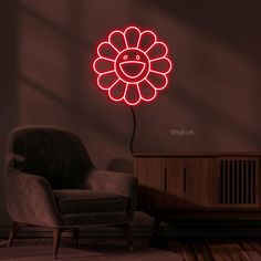 a living room with a chair and a flower shaped neon sign on the wall above it