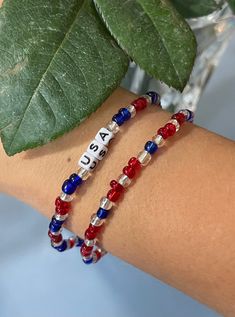 Red, white, and blue beads with USA name Everyday Red Stretch Bracelet With Round Beads, Patriotic Colorful Beads Bracelet For Gift, Patriotic Multicolor Friendship Jewelry, Multicolor Round Beads Bracelet For 4th Of July, Red Beaded Bracelets For Everyday Wear, Patriotic Red Beaded Bracelets, Patriotic Blue Friendship Bracelets, Blue Patriotic Bracelet For Friendship, Patriotic Red Beaded Bracelets As Gift