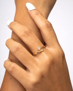 The definition of beauty in simplicity. The Liana Ring is a refined & dainty piece crowned with a timeless white zirconia stone. A minimalist treasure where the effortless elegance shines in itself. A harmony of delicacy and character in an ethereal and bright adornment. 18k Gold Vermeil White Zirconia stone Adjustable Hypoallergenic & non-tarnish Style Tips: The Liana Ring is a fine beauty worn on its own but to amplify the class, wear it with our Hazel Ring and Yumi Bracelet, for a ref Delicate Open Diamond Ring With Brilliant Cut, Minimalist Jewelry With Brilliant Cut Open Ring, Minimalist Open Ring With Brilliant Cut, Minimalist Open Ring With Brilliant Cut For Wedding, Delicate Diamond White Rings With Prong Setting, Minimalist Cubic Zirconia Open Band Diamond Ring, Elegant Open Ring With Single Diamond, Dainty Open Diamond Ring With Brilliant Cut, Dainty Diamond Ring With Brilliant Cut