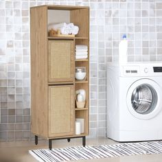 a washer and dryer sitting next to each other in front of a tiled wall