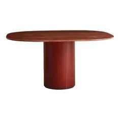 a round wooden table sitting on top of a white floor next to a red wall