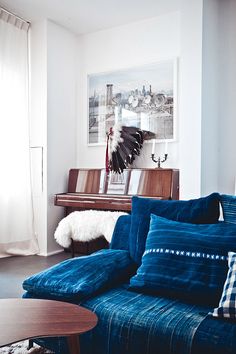 a living room filled with furniture and a piano