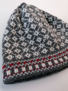 Knitted winter hat. Medium size available appr.56-58 cm head circmference. Traditional small nordic star pattern - dark grey or black variation is available. 100% lambs wool, without lining. Double edge, to keep hat more fit. This hat is unique - unisex model. Very well matching to men. There is used 2 basic colour for white star pattern: main colour is dark grey or black.. The edge has block striped pattern, red stripes included. Medium size - head circumference appr.56-58 cm, length 22 cm. Siz Etnic Style, Wool Leg Warmers, Wool Hat Knit, Fair Isle Knitting, Basic Colors, Winter Knits, Wool Hat, Nordic Style, Star Patterns