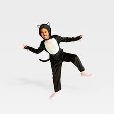 Add some feline fun to your kid's Halloween with this Alley Cat Jumpsuit Halloween Costume from Hyde & EEK! Boutique™. This kids' two-piece costume accessory set includes a full-length jumpsuit in shimmery black and white with long sleeves with thumbhole cuffs as well as an attached hood with pointy white cat ears sticking out. A matching black tail completes the cute, classic look. Hyde & EEK! Boutique™: Thrilling delights. Curious oddities. Boys Cat Costume, White Cat Ears, Halloween Costume Jumpsuit, Mummy Halloween Costume, Bat Halloween Costume, Dragon Halloween Costume, Cat Costume Diy, Cat Jumpsuit, Dragon Halloween