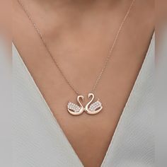 925 Sterling Silver Swan Necklace, Swan Pendant, Necklace for Women, Gift for Her, Mothers Day Gifts, Anniversary GiftsMetal Used: 925 Sterling SilverNecklace Weight : 1,90 GrFigure Width: 2.00 CmFigure Height :1,20 CmNecklace Chain Length : 42 CmStone Type : ZirconCoating : Rose Gold PlatedCare: It does not darken as long as contact with substances such as perfume, alcohol, cream, bleach is avoided.Packaging: All Products Are Sent In Gift Box.Your necklaces are delivered in their special boxes. Swan Pendant Gold, Rose Gold Sterling Silver Charm Necklace For Anniversary, Rose Gold Pendant Charm Necklace For Anniversary, Elegant Sterling Silver Charm Necklaces For Anniversary Gift, Sterling Silver White Gold Necklaces For Anniversary Gift, Silver Fine Jewelry Necklace For Anniversary, Elegant Sterling Silver Charm Necklace For Anniversary, Dainty Silver Necklace For Anniversary Gift, Sterling Silver Pendant Necklace For Anniversary