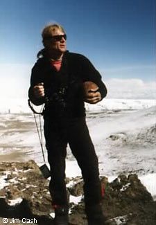 a man standing on top of a snow covered mountain