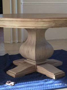 a wooden table sitting on top of a blue mat