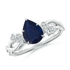 an oval shaped blue sapphire and diamond ring with two white diamonds on the shoulders, set in