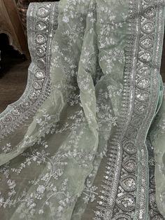 Gorgeous light mint green organza dupatta with silver embroidery and heavy sequins border. Pista Green Dupatta With Intricate Embroidery For Diwali, Elegant Silver Dupatta With Chikankari Embroidery, Festive Green Embroidered Fabric With Sheer Dupatta, Silver Traditional Wear With Chikankari Embroidery For Weddings, Green Dupatta With Intricate Embroidery In Organza, Green Embroidered Sheer Dupatta Fabric For Wedding, Green Embroidered Fabric With Sheer Dupatta For Wedding, Pista Green Dupatta With Intricate Embroidery, Green Embroidered Sheer Dupatta For Wedding