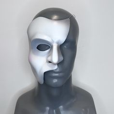 Inspired by the Toronto production and the iconic style of musical theatre legend Colm Wilkinson, this mask exhibits more expressive features, with sharp angles and a slightly more dramatic paint scheme.  D E T A I L S : -- Lightweight & durable -- Airbrushed with water-based latex paint which resists peeling and cracking -- Painted using Maria Björnson's original shading instructions -- Thermoformed with high impact polystyrene plastic -- 18 gauge steel wire attached for easy wear (heavy-duty r Artistic Masks For Theater And Halloween, Artistic Halloween Masks For Theater, Artistic Halloween Theater Masks, Artistic Masks And Prosthetics For Theater Halloween, Artistic White Mask For Theater, Artistic White Masks And Prosthetics For Theater, Artistic Full Face Mask For Costume Party, Artistic White Masks For Costume Party, Artistic Masks For Art Events