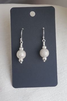 Use code NEWYEAR15 for a fab discount on purchases over £10. Gorgeous Stardust Earrings - Sterling Silver. A fabulous pair of Stardust bead earrings. With small plain Sterling Silver beads and larger Silver Stardust textured beads, these are an unusual and stunning pair. Lovely to give as a gift or as a special treat for yourself. Use code SPOOKY10 for a fab discount on all your purchases. Please note I am only posting out items once a week for the foreseeable future. This will be on Thursdays (unless otherwise stated in an email/message at time of purchase). Please be patient and understanding of any delay. Earring length is approx 1.5 inches (3.8cm) long from the top of the ear wires to the bottom of the beads. All parts are Sterling Silver. Small plain beads are 5mm and large stardust b Silver Earrings Handmade, Beads Earrings, Unusual Jewelry, Amethyst Color, Valentine Special, Earring Cards, Just Because Gifts, Red Crystals, Bead Jewellery