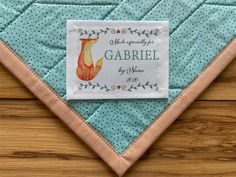 a label on a quilted piece of cloth that says, made specifically for garriel by me