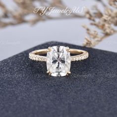 an oval cut engagement ring with pave diamonds