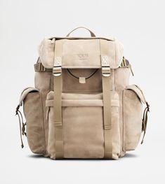 Backpack in suede, with handle strap and adjustable shoulder straps. Closed with flap and branded metal buckles, it features a flat upper pocket and wide zipped front pocket. The sides come with practical flap pockets, while the interior comes with a drawstring with branded slider. A refined synthesis of artisanal taste and functionality. Leather Flap Bag With Buckle Closure, Leather Bag With Buckle Closure And Flap, Luxury Daily Use Bags With Adjustable Straps, Luxury Leather Bags With Multiple Pockets, Luxury Leather Bag With Pockets, Suede Travel Bag With Leather Trim, Outdoor Leather Bag With Detachable Strap, Travel Suede Bag With Leather Trim, Designer Leather Bag With Pockets