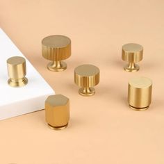 brass knobs and handles on a beige background