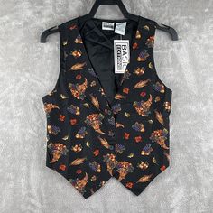 This vintage Basic Editions vest is a unique piece that will add character to any outfit. The black canvas vest features a beautiful floral pattern with accents of leaves, fruits, and veggies. It has a sleeveless design and a button closure, making it perfect for layering over a shirt or blouse. The vest is made of 100% cotton, making it machine washable and easy to care for. We take great pride in carefully curating our products, hand-selecting each one with care. When it comes to secondhand cl Canvas Vest, Vest Pattern, Vest Outfits, Womens Basic, Black Canvas, Fruits And Veggies, Black Pattern, Black Orange, Skirt Fashion