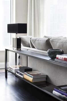 a living room filled with furniture and a large window