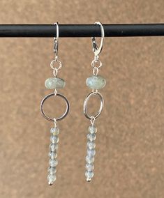 These drop earrings are handcrafted with labradorite gemstones. A 6mm rondelle stone is the focal point. From the stone hangs a 12 mm silver plated ring which holds a labradorite bar pendant made up of seven 4 mm stones. The overall length is 2.5 inches. The earring style is a hypoallergenic stainless steel lever back. Sterling Silver Gray Dangle Jewelry, Gray Sterling Silver Dangle Jewelry, Gray Sterling Silver Dangle Earrings, Ear Rings, Bar Pendant, Handcrafted Earrings, Plated Ring, Etsy Earrings Dangle, Crafts Ideas