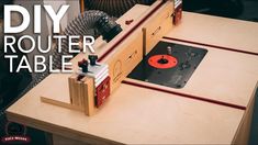 the router table is made out of plywood and has red tape on it