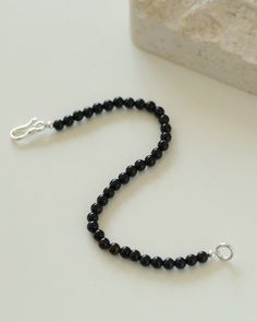 Add a touch of sophistication to your wrist with our Black Onyx Beaded Bracelet—a sleek and versatile accessory that seamlessly blends the timeless beauty of black onyx beads with a minimalist design. Metal: Recycled Sterling Silver Gemstone: Black Onyx 4mm Length: 170mm Weight: 5g Minimalist Onyx Beaded Bracelets With Round Beads, Minimalist Black Onyx Beaded Bracelets, Minimalist Onyx Beaded Bracelet With Round Beads, Minimalist Onyx Beaded Bracelet, Minimalist Black Onyx Bracelet, Classic Black Beaded Bracelets For Everyday, Minimalist Single Strand Beaded Bracelets With Round Beads, Minimalist Single Strand Beaded Bracelet, Elegant Black Bracelets With Faceted Beads