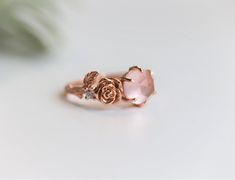 "Handcrafted in a metal of your choice, this intricate ring features a hand-carved rose, set beside a beautiful rose cut rose quartz stone, with nestled sparking moissanite and carved delicate leaves beside them. The band of the ring is twig textured like the stem of a rose and adds the perfect detail to the ring. This ring is wonderful for a sweet valentine's day gift or promise ring that will last for a lifetime. ---------------------- NOTE ➤ This item is made to order, please allow 2-3 weeks Thorn Ring, Ring Rose Quartz, Botanical Ring, Intricate Rings, Rose Thorns, Rose Gold Quartz, Rose Quartz Ring, Rose Quartz Stone, Rose Ring